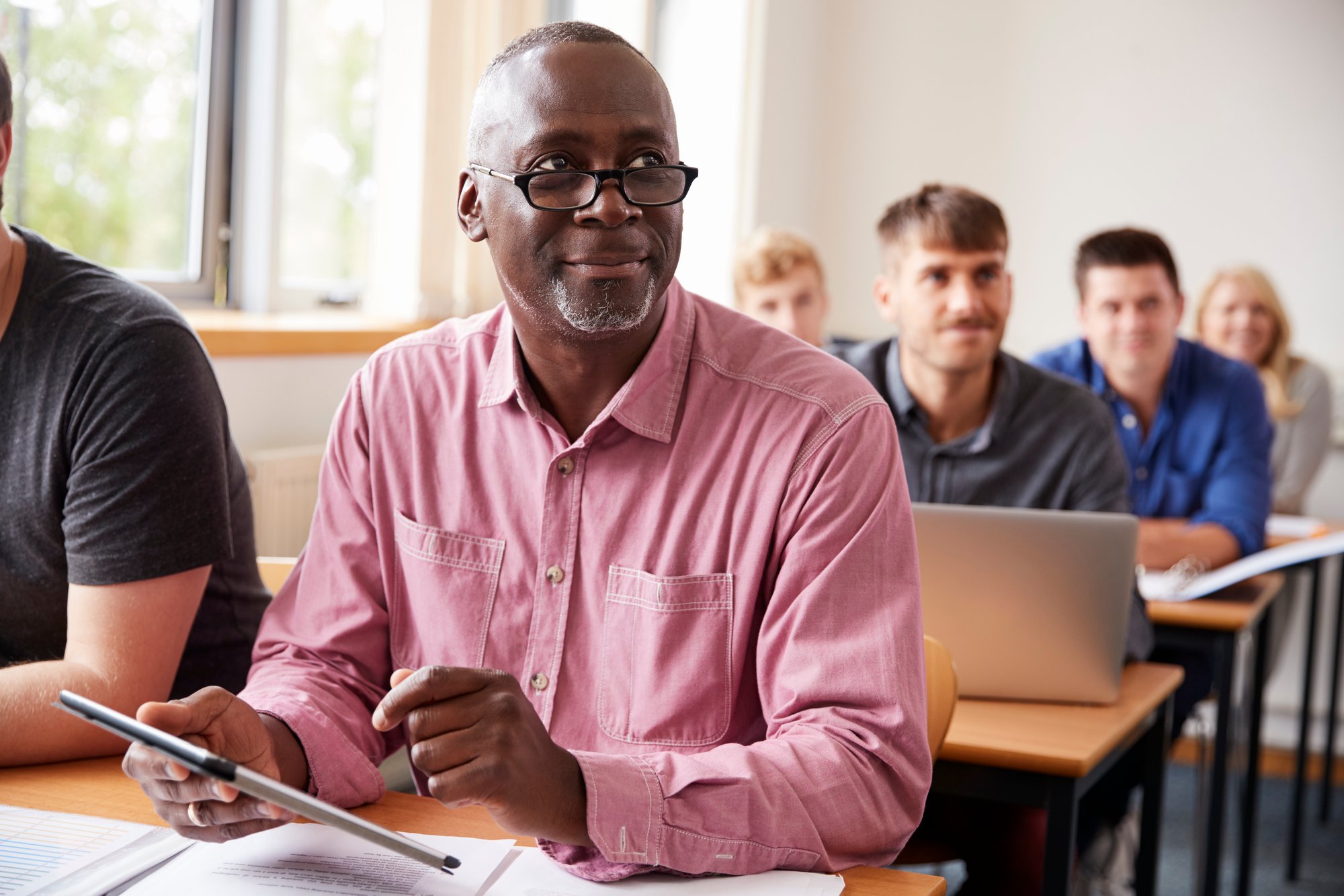 mature-student-using-digital-tablet-adult-education-class