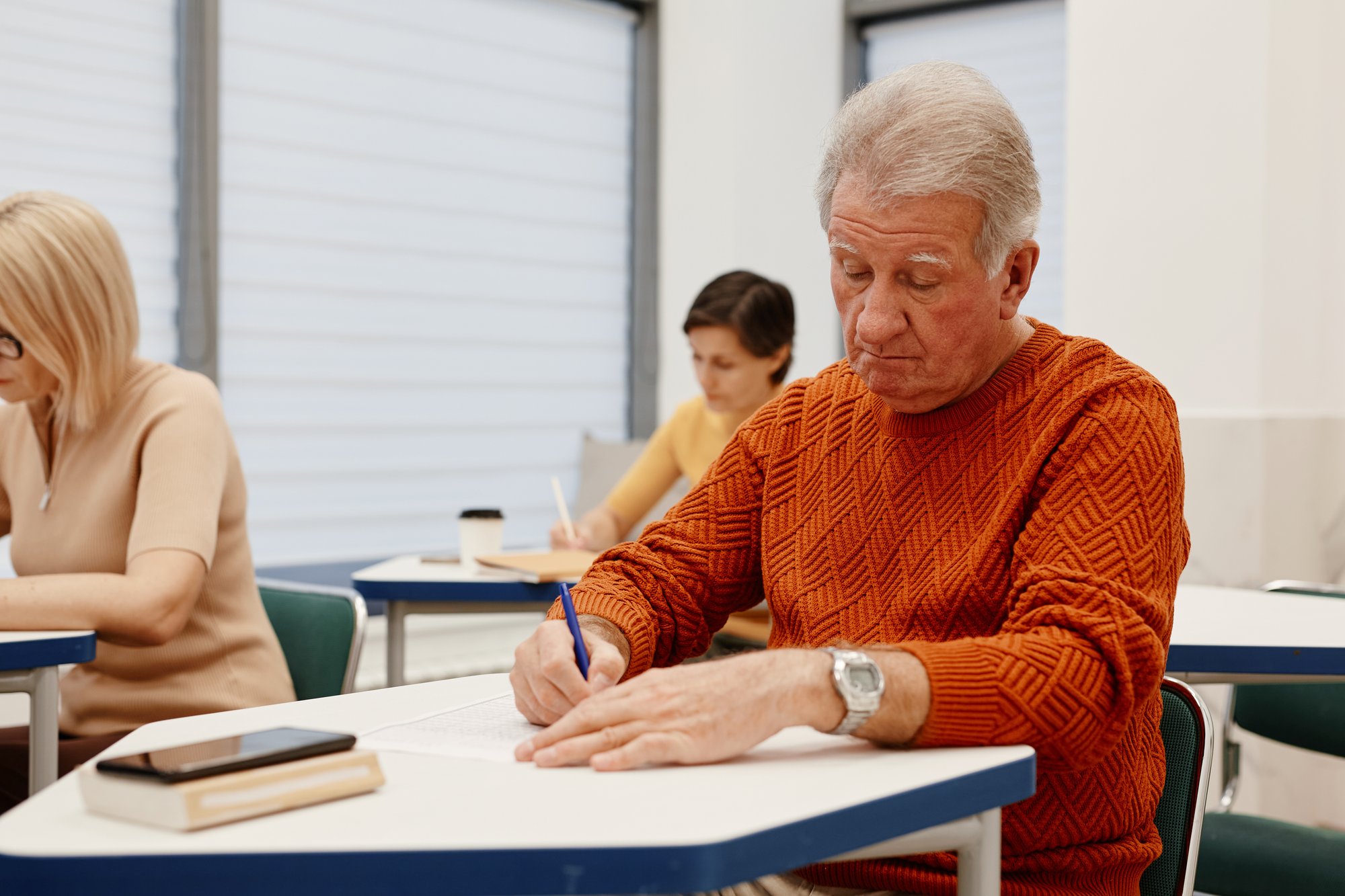 senior-man-making-notes-training