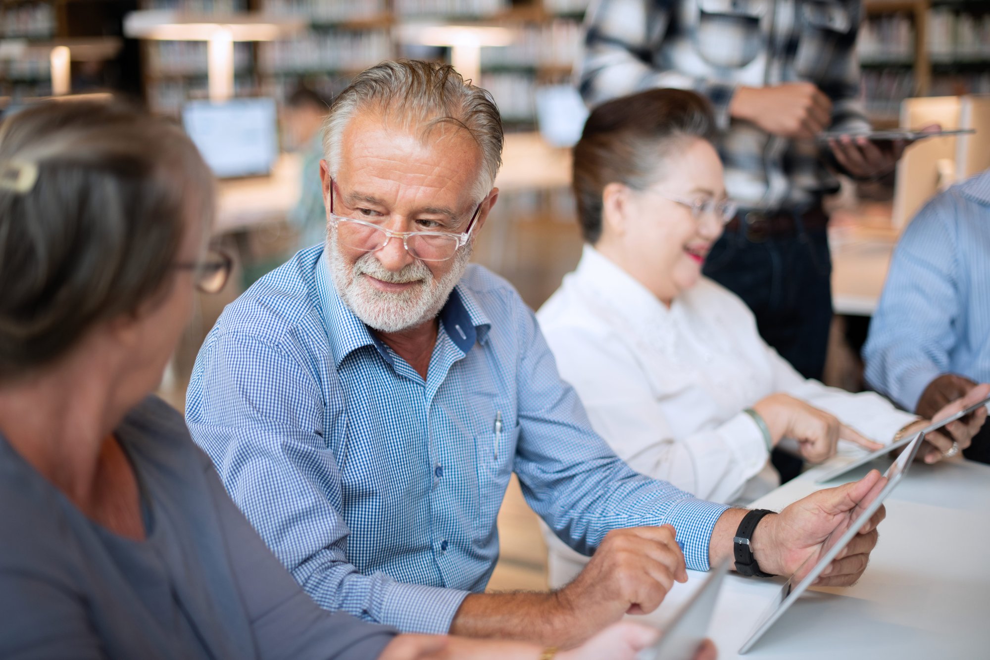 senior-man-woman-using-tablets-library-elderly-man-woman-enjoying-technology-group-seniors-library-setting-engaging-with-tablets-social-media-learning-modern-technology-1